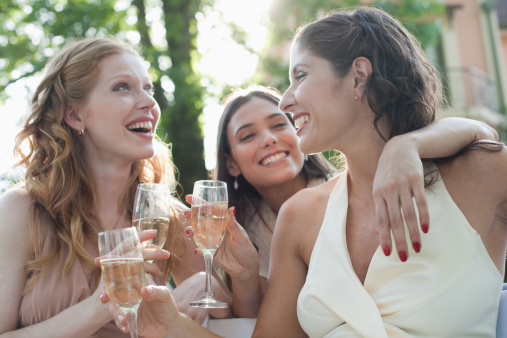 bridal party with three women drinking wine