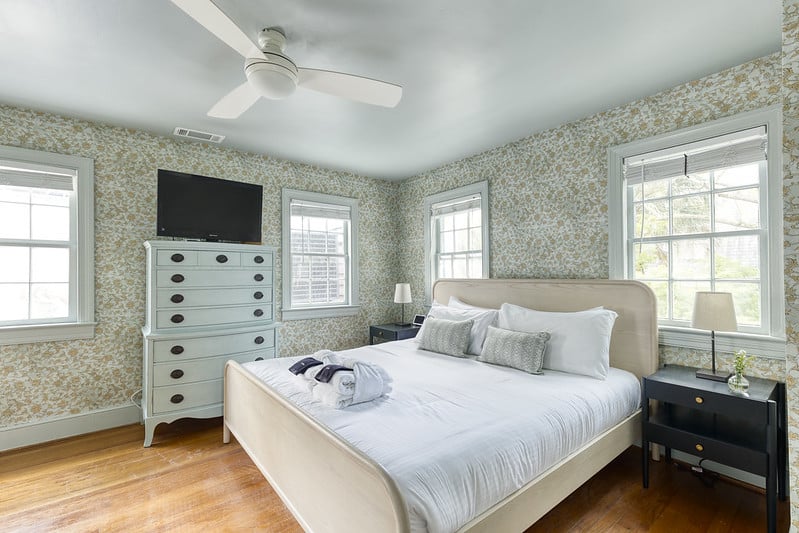 the ashley inn carriage house bedroom with king bed and tv